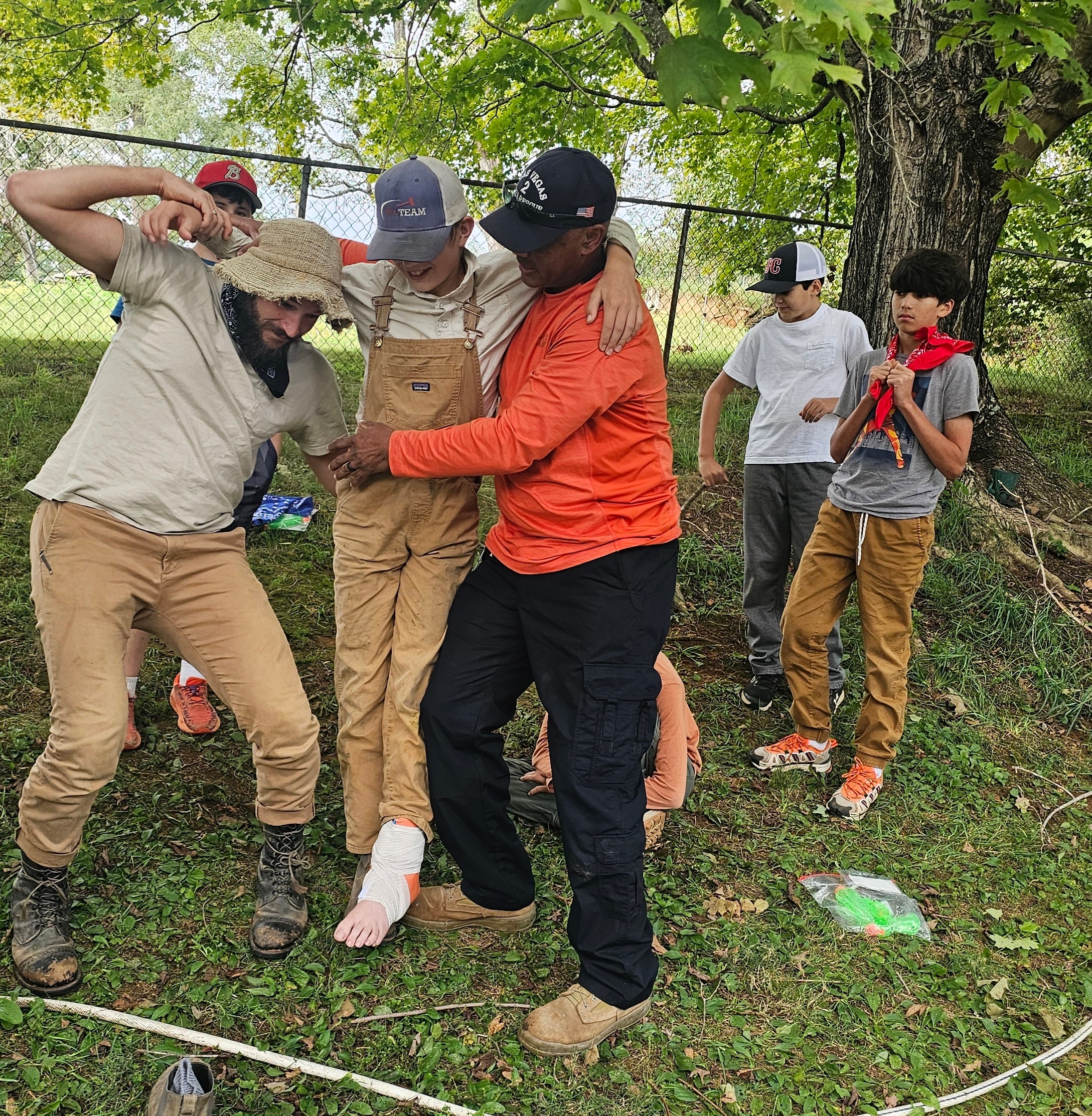 Students and guides practicing a first aid carry activity outdoors